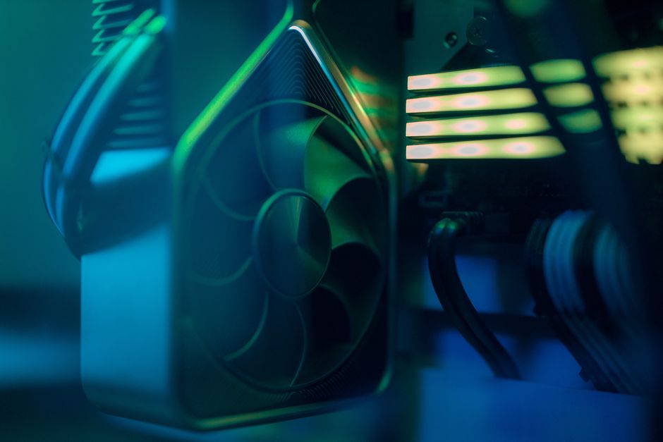 Detailed close-up of a computer cooling fan inside a custom PC with LED lighting, emphasiz