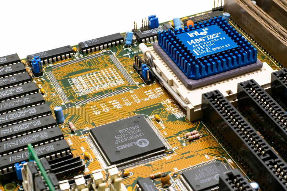 Detailed view of an Intel i486 DX2 CPU installed on a vintage motherboard with chips and c