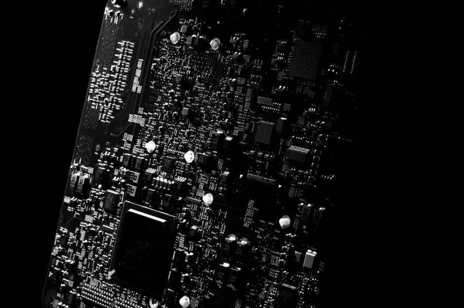 Detailed black and white close-up of a circuit board showcasing modern technology.